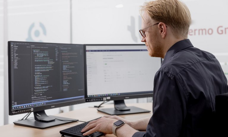 TILMedia User Engineer works with TILMedia on his computer.